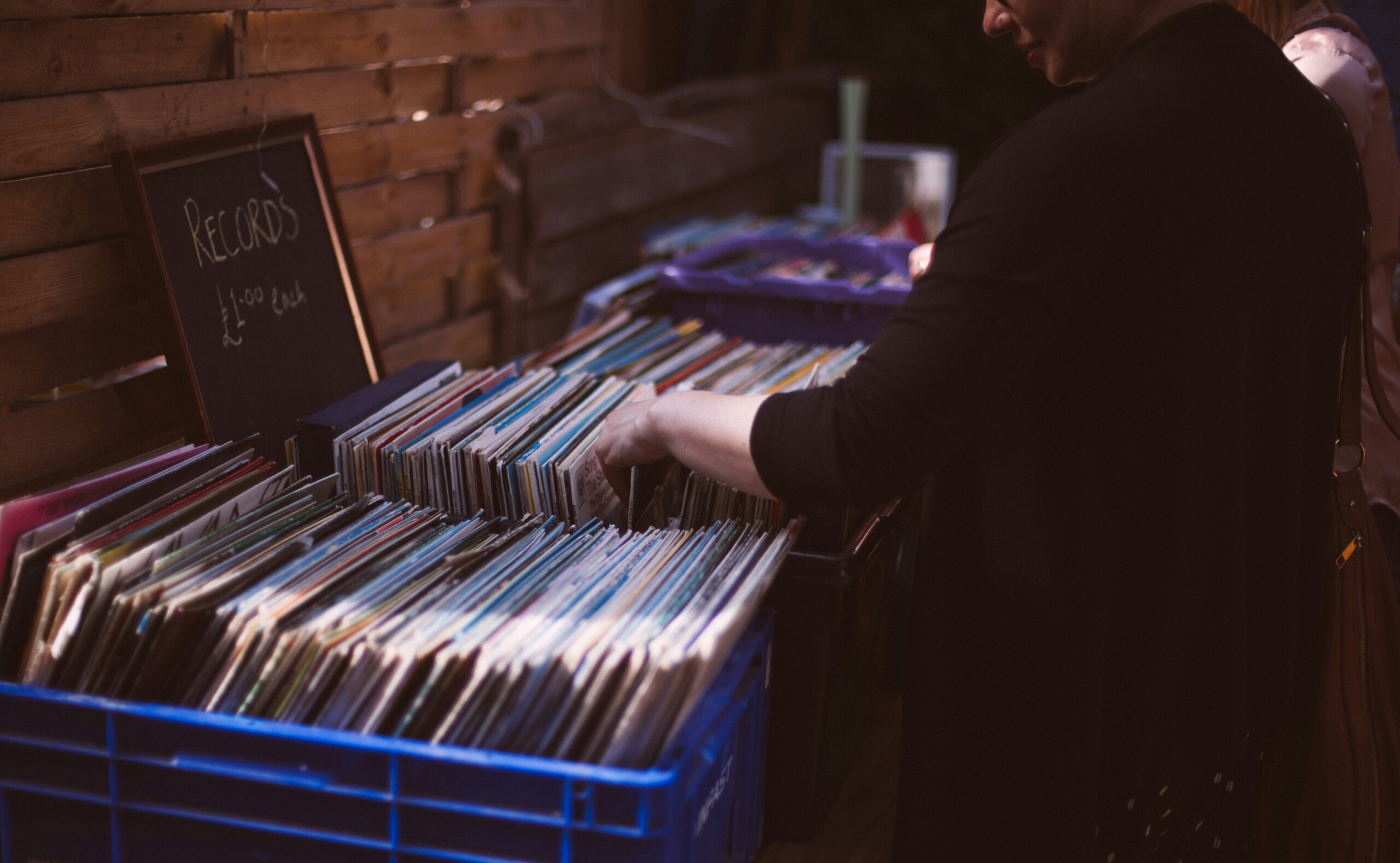 woman browsing used records at a garage sale