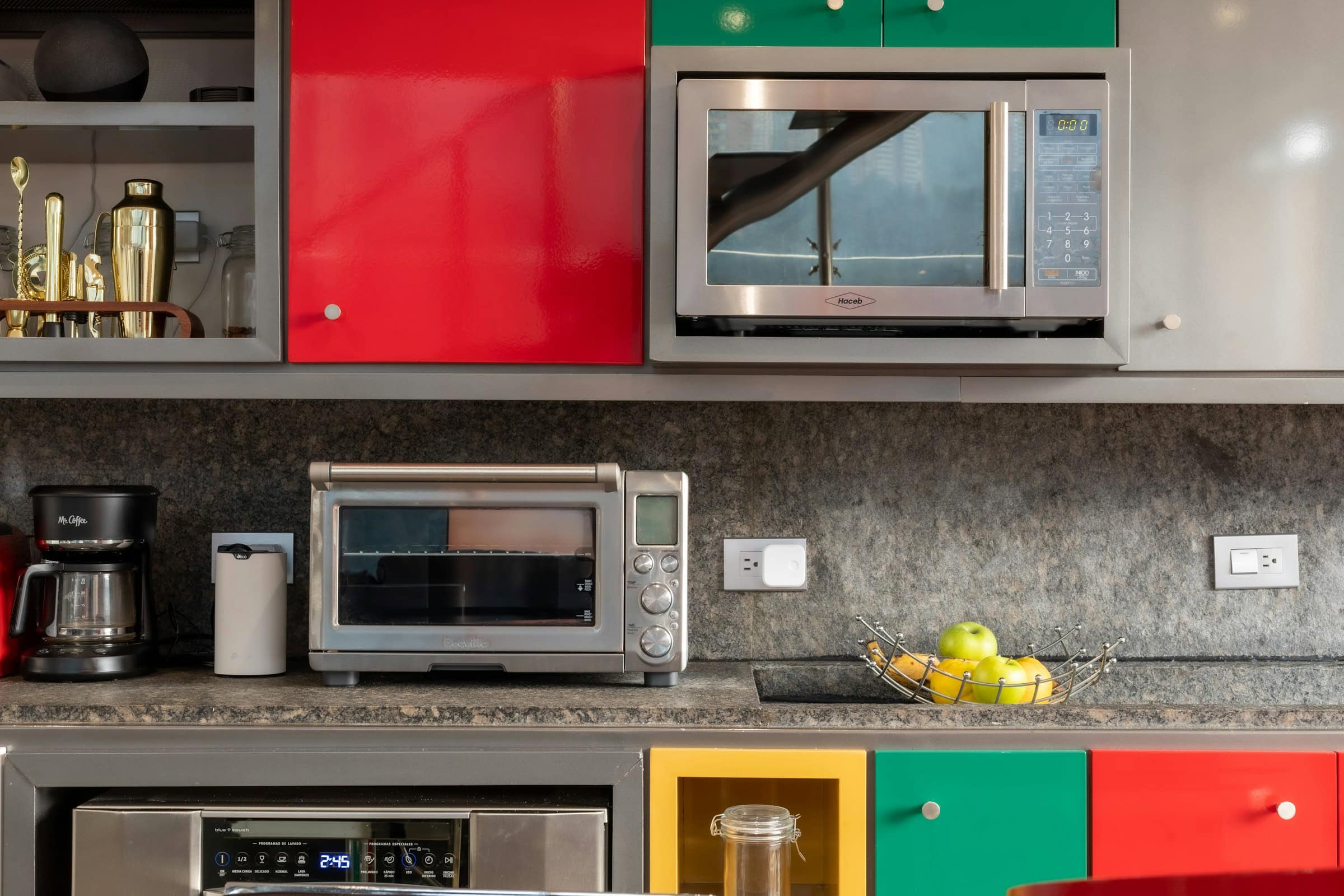 kitchen appliances staged on colorful cabinets