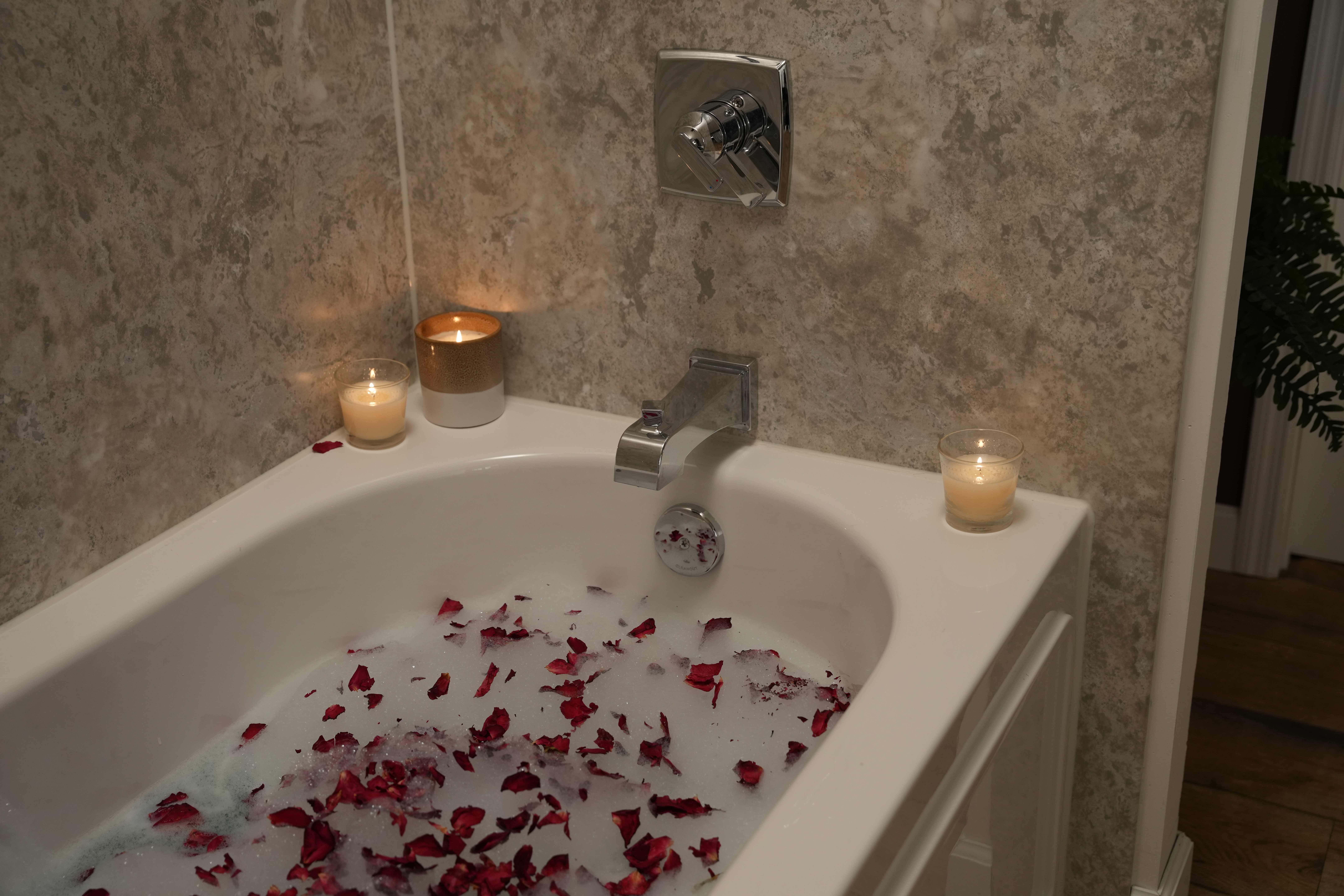bathtub with candles and rose petals|bathroom remodel|bathroom accessories and flowers|lavender|zen bathtub||